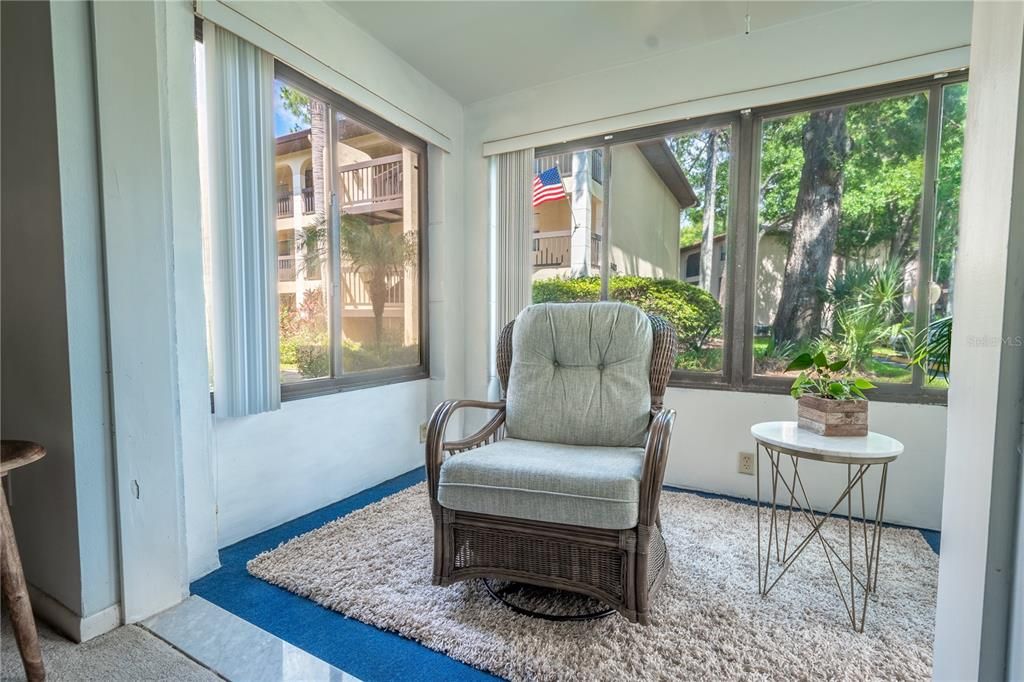 The living room is open to a screened in porch/FLorida room.