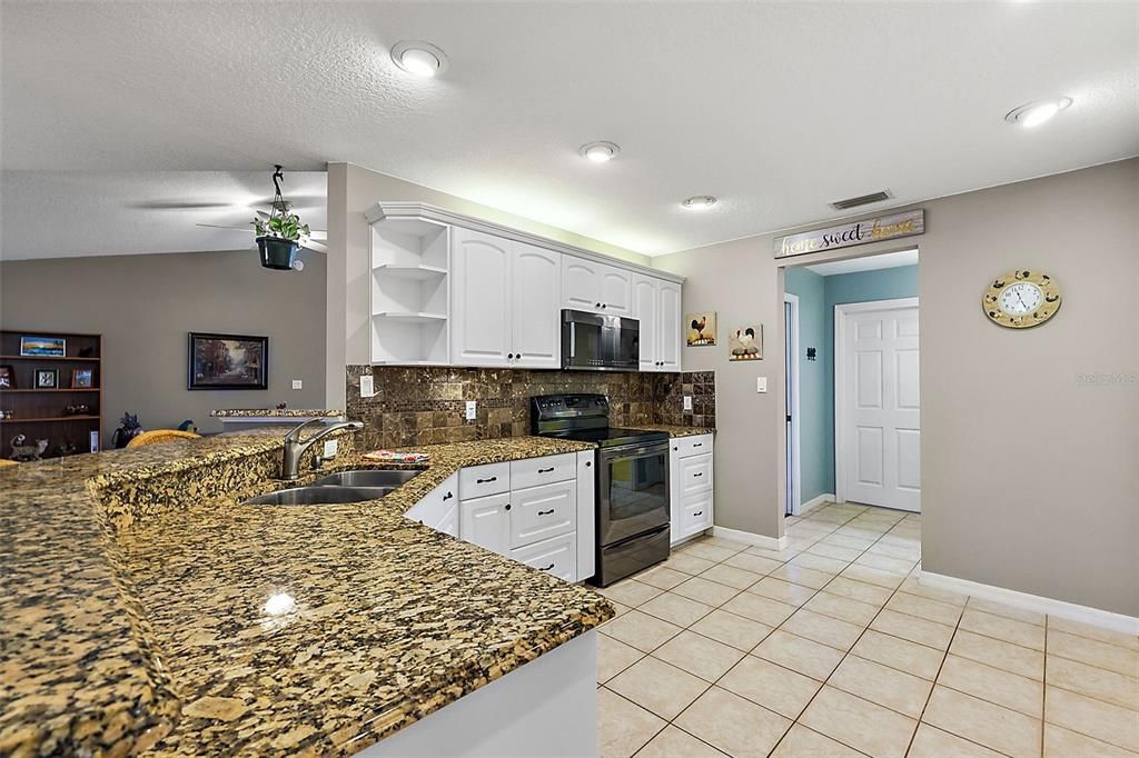 Granite counters, tile flooring, and tile backsplash complete this fabulous kitchen