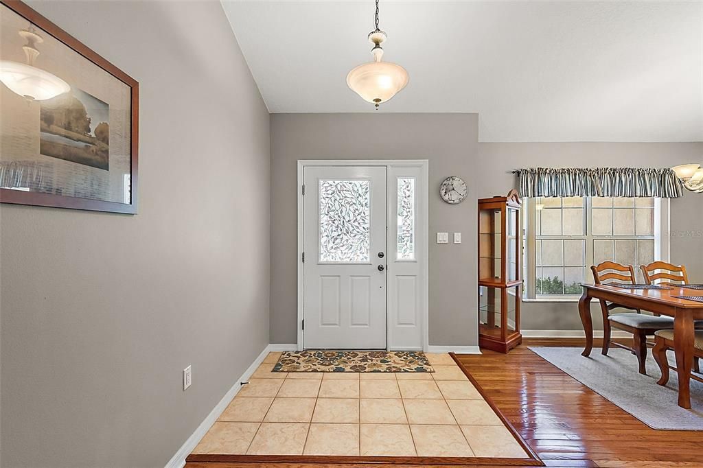 Spacious foyer with tile and soaring vaulted ceilings