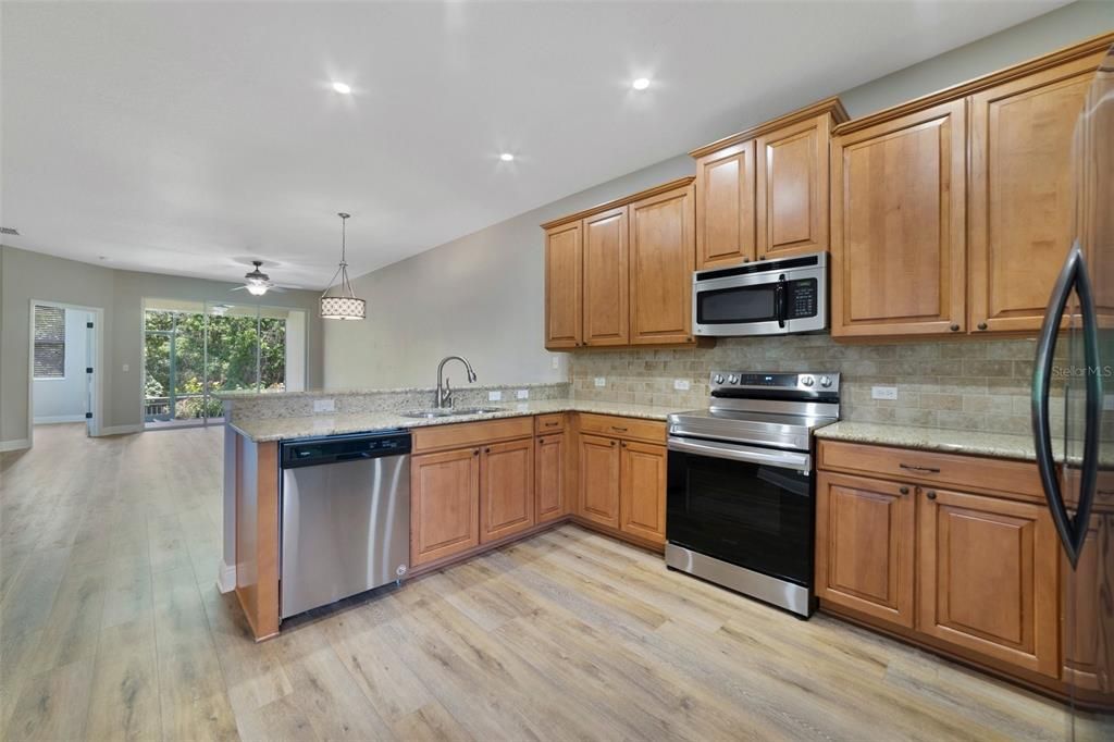 Kitchen overlooks dining & living rooms