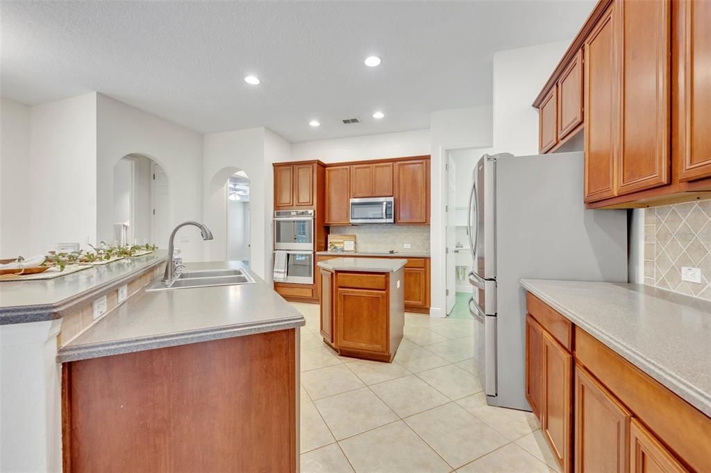 Kitchen boasting corian countertops and new applicances (refrigerator is not brand new)