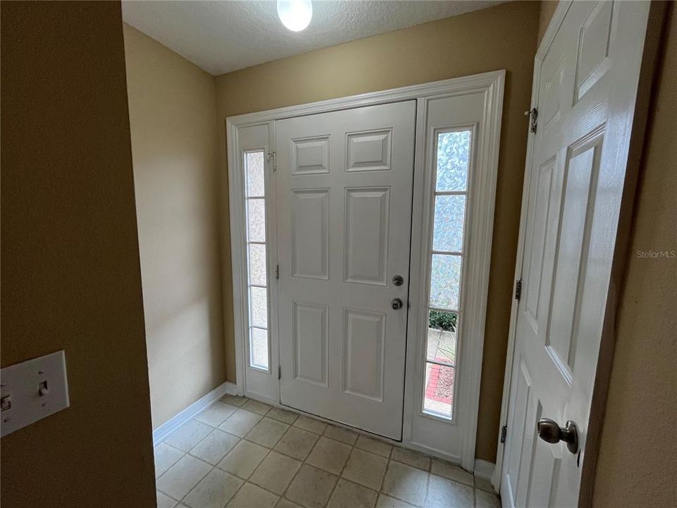 Foyer and front hall Brand new bifold doors at laundry closet