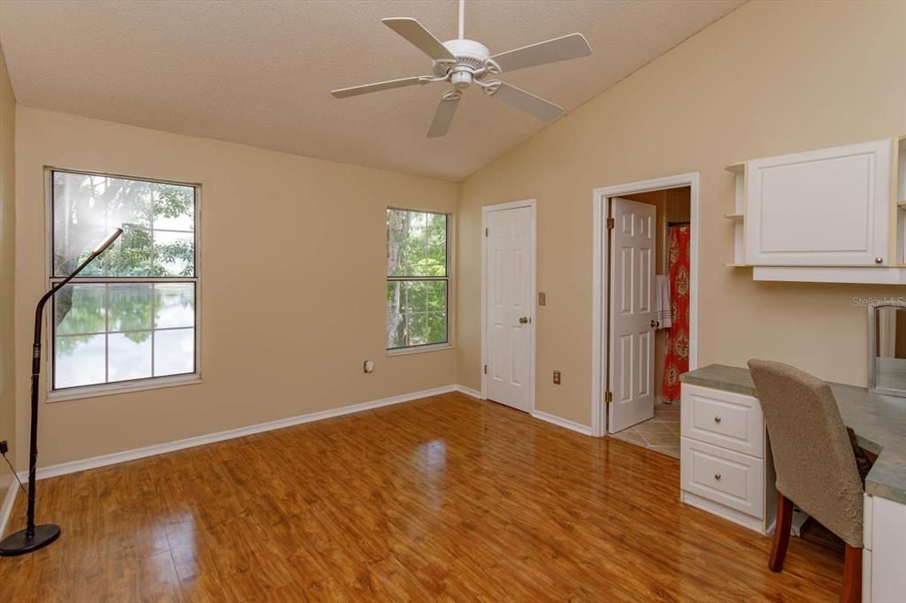 14' x 12' primary bedroom with vaulted ceiling, walk-in closet and ceiling fan