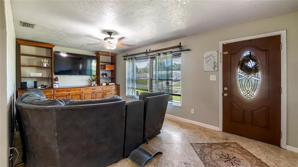 This home features travertine tile throughout and NO popcorn ceilings throughout.