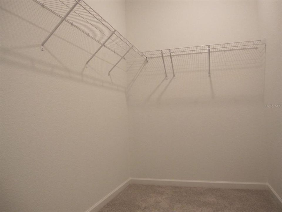 Primary bedroom inside walk-in closet