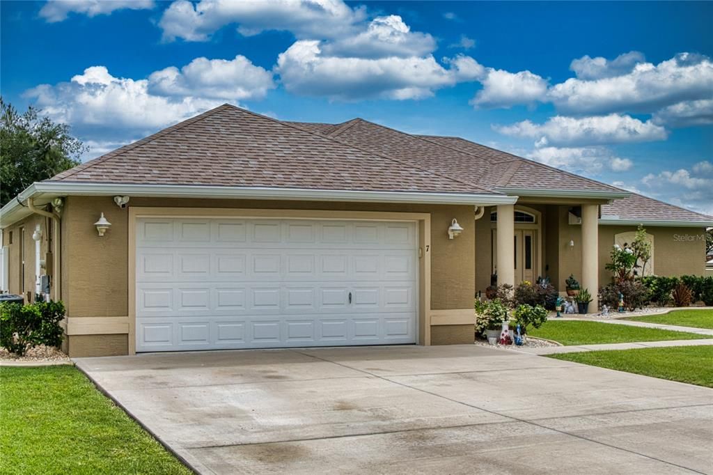 An oversized driveway and well-maintained gutters enhance the home's charming exterior in the desirable Matanzas Woods Subdivision.