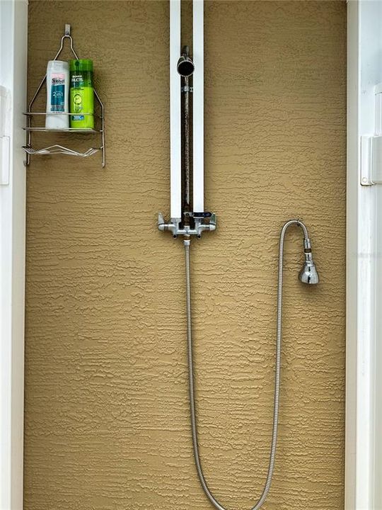 The private outdoor shower enclosure includes a high shower head for your comfort and a flexible head for easy washing of feet, dogs, and more.
