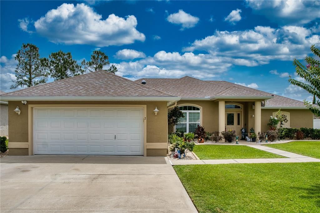 A delightful walkway leads to the inviting front entryway, showcasing the home's welcoming atmosphere.