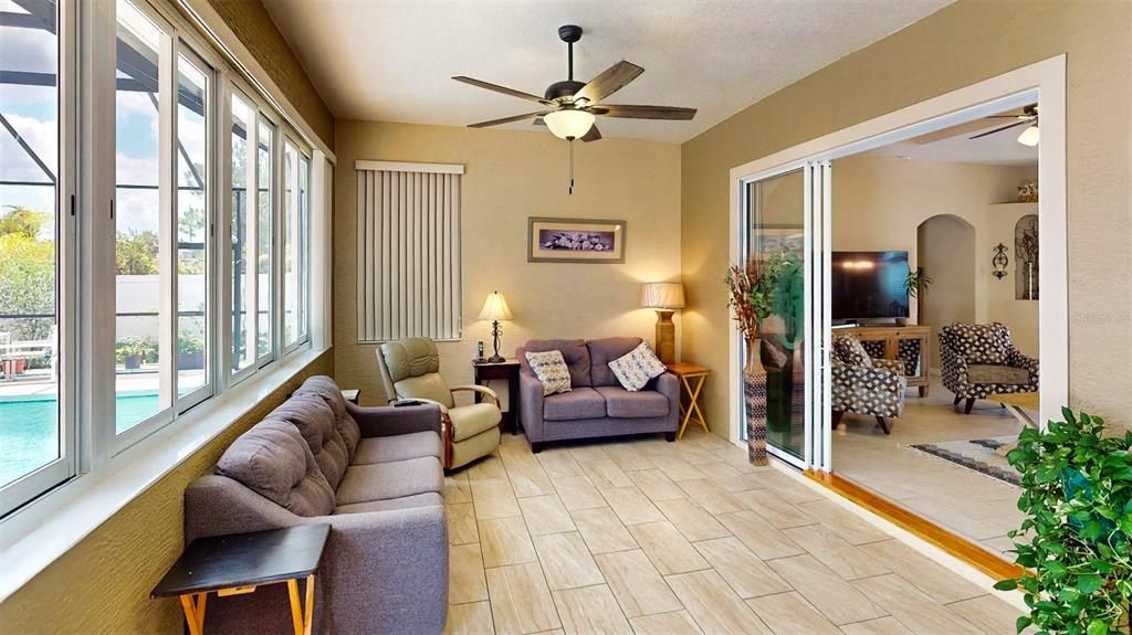 The 3-door sliding glass door can separate the Florida room from the living room when desired. Additionally, the upgraded A/C system heats the Florida room, allowing it to be left open year-round if preferred.