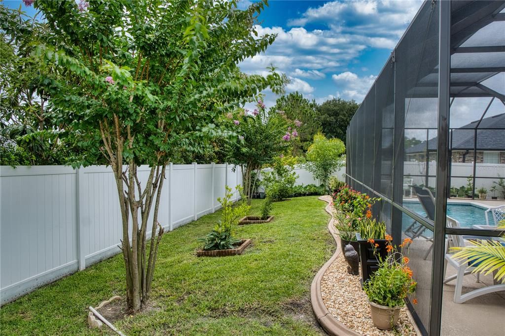 Private white privacy fence surrounding the entire backyard, ensuring seclusion and peace.