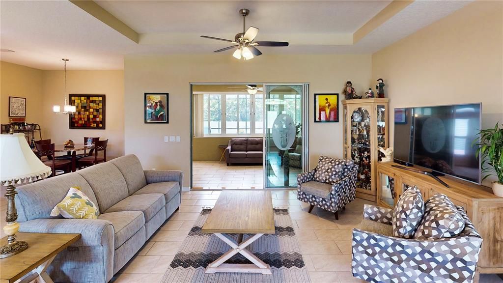 Amazing family room overlooking the Florida room and pool, featuring a recessed tray ceiling for added elegance.