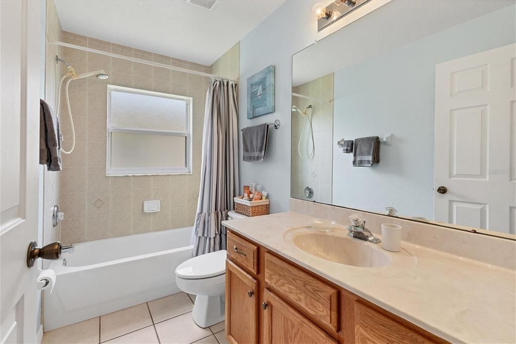 Guest bath tub shower combo, tile surround, window