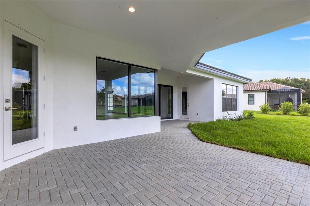 Large covered lanai with multiple spaces "under roof" areas.