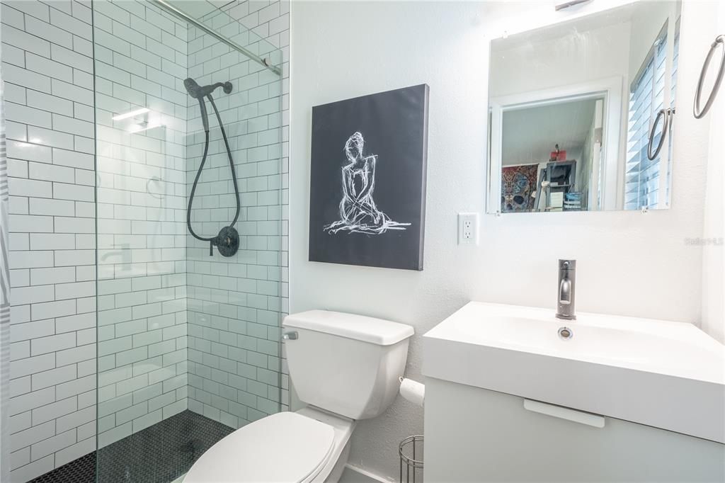 Bathroom 3  features a tiled walk-in shower, and a mirrored vanity with storage all bathed in a neutral color palette. This is an ensuite for bedroom 4.