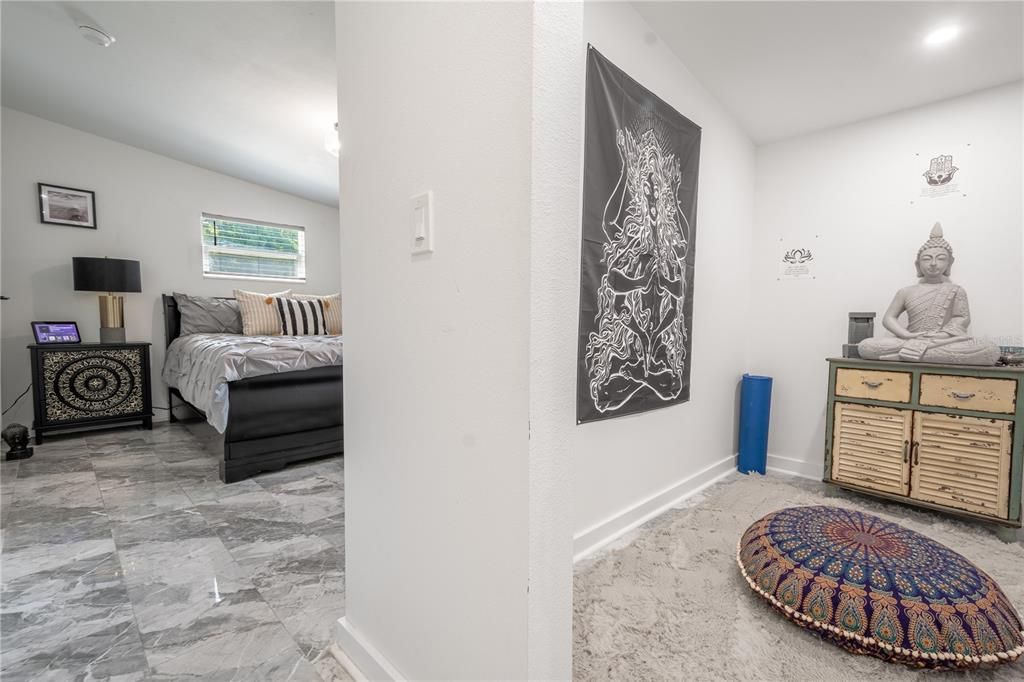 The primary bedroom features a large walk-in closet which the current owner is using as a meditation room.