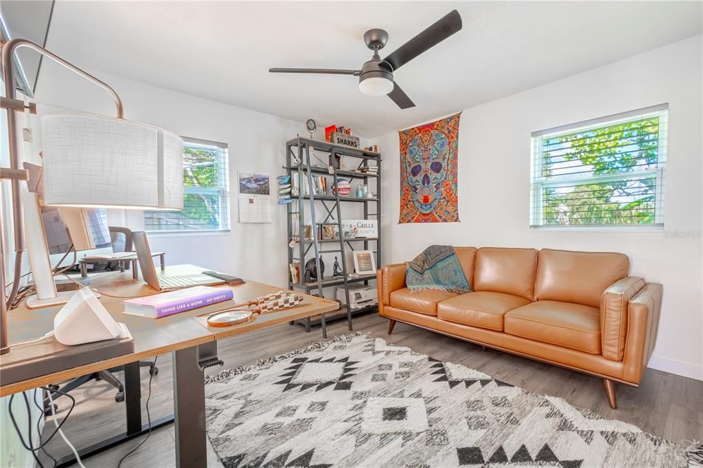 Bedroom 4 is currently used as a home office. It features wood laminate flooring, neutral tones, a ceiling fan and built in closet. This also has an ensuite bath ideal for guests.