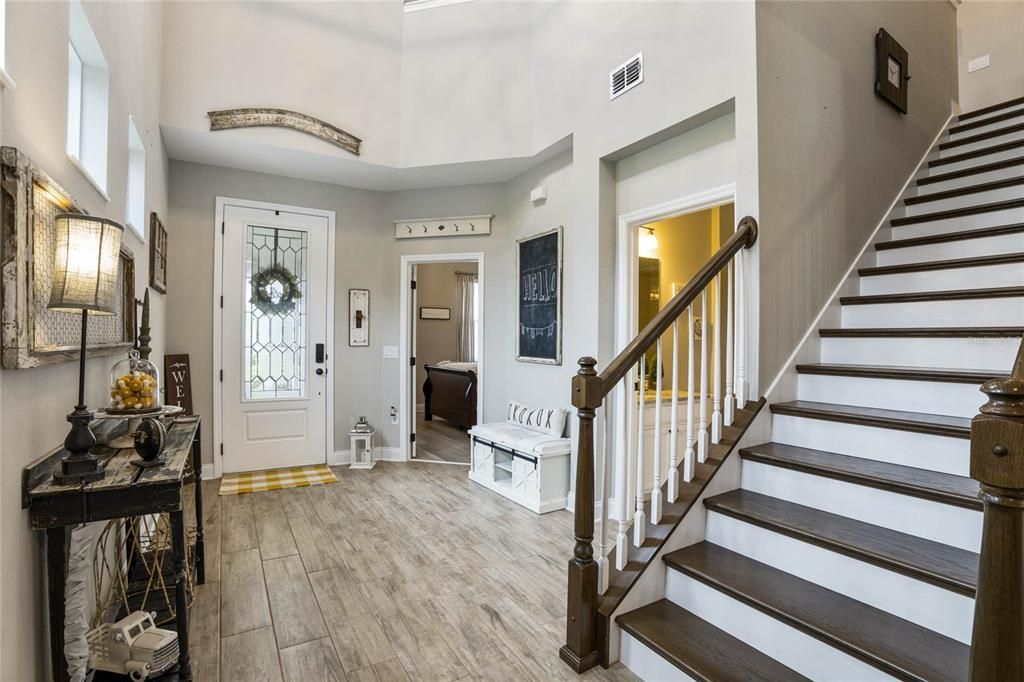 Looking from iving room to foyer. Solid wood stair treads.