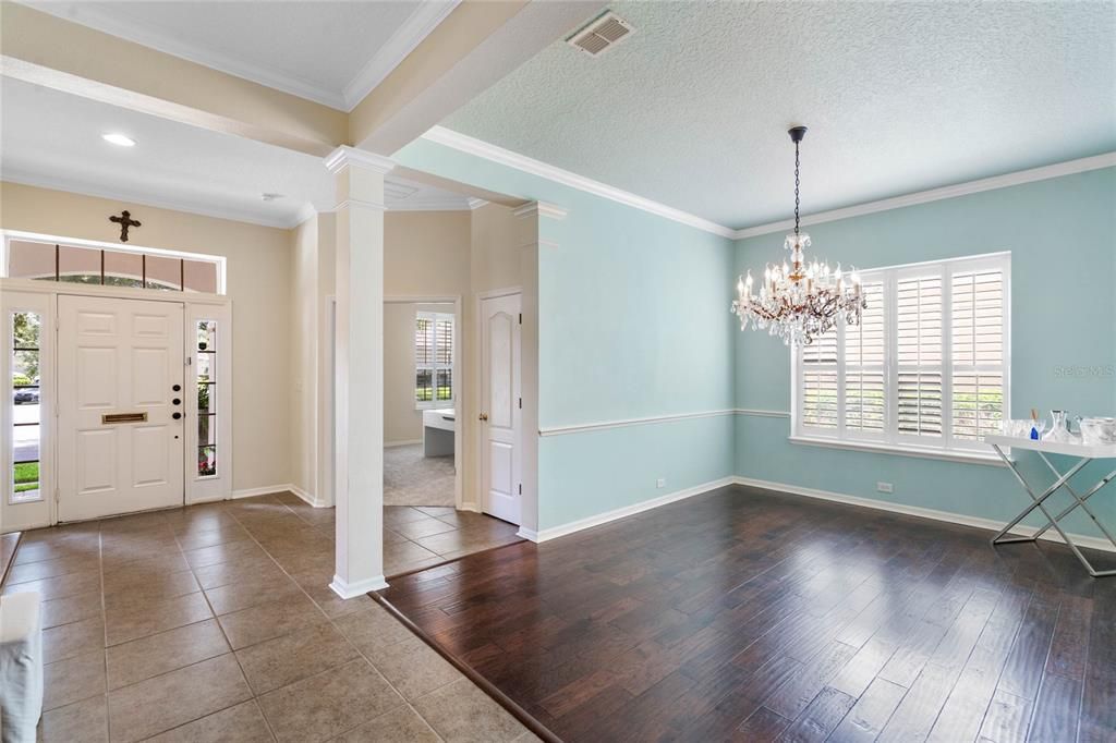 Foyer opening to office and formal dining room