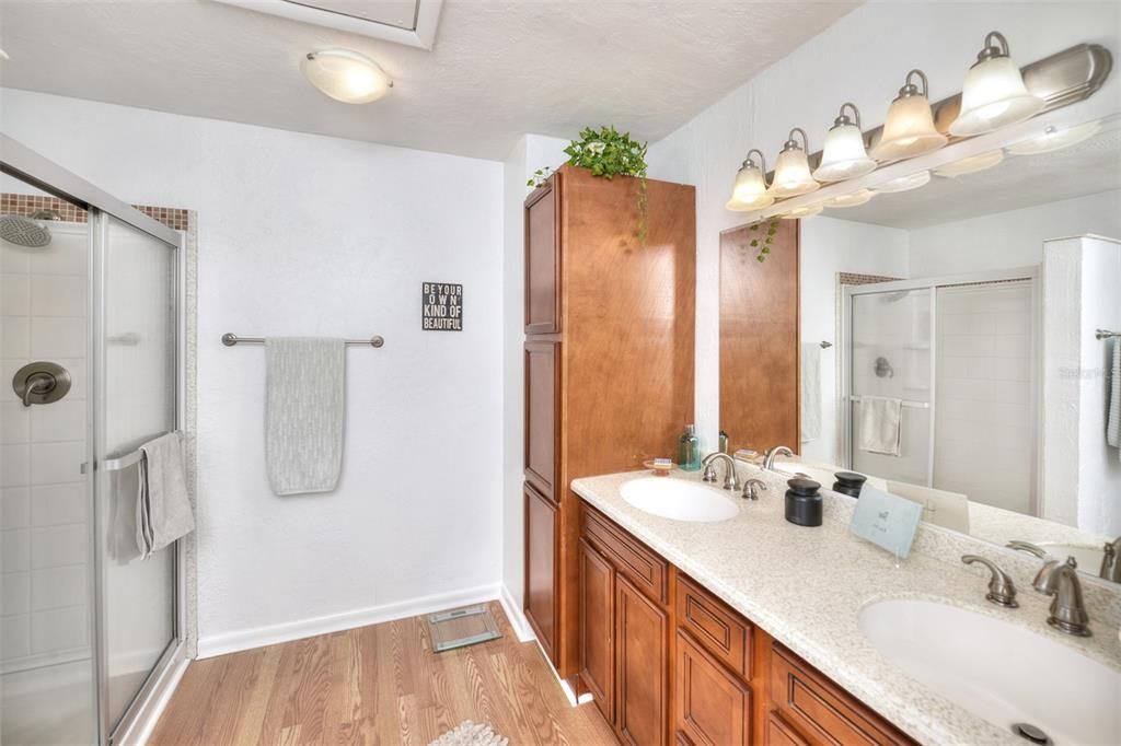 Owner's bath with walk-in shower and double vanities and Corian counters.