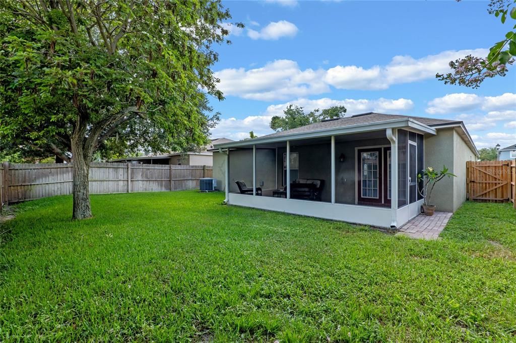 Screened patio and manicured back yard.