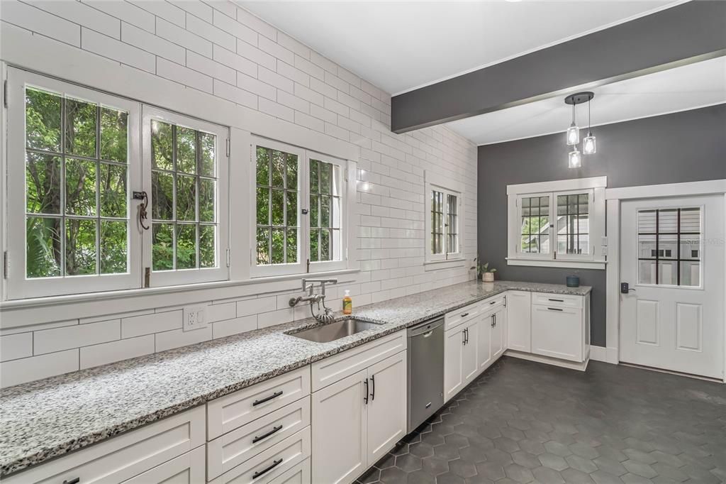 Kitchen with view of door to back screened porch and laundry closet