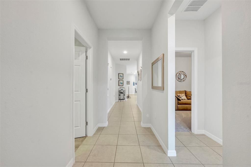 View of the home from entry door leading towards de ki  Two bedrooms and a bathroom on the right side, and one bedroom on the left.