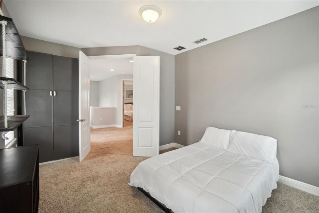 Bedroom 3 features paneled headboard and ceiling fan