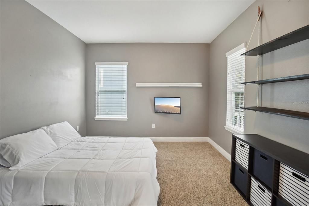 Bedroom 2 features french doors and armoire