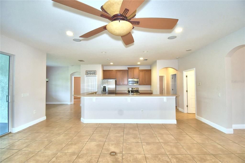 View from Family Room toward kitchen with laundry on right followed by SW Bath and SW Bedroom.  Breakfast Nook and SE Bedroom with ensuite is on the left.