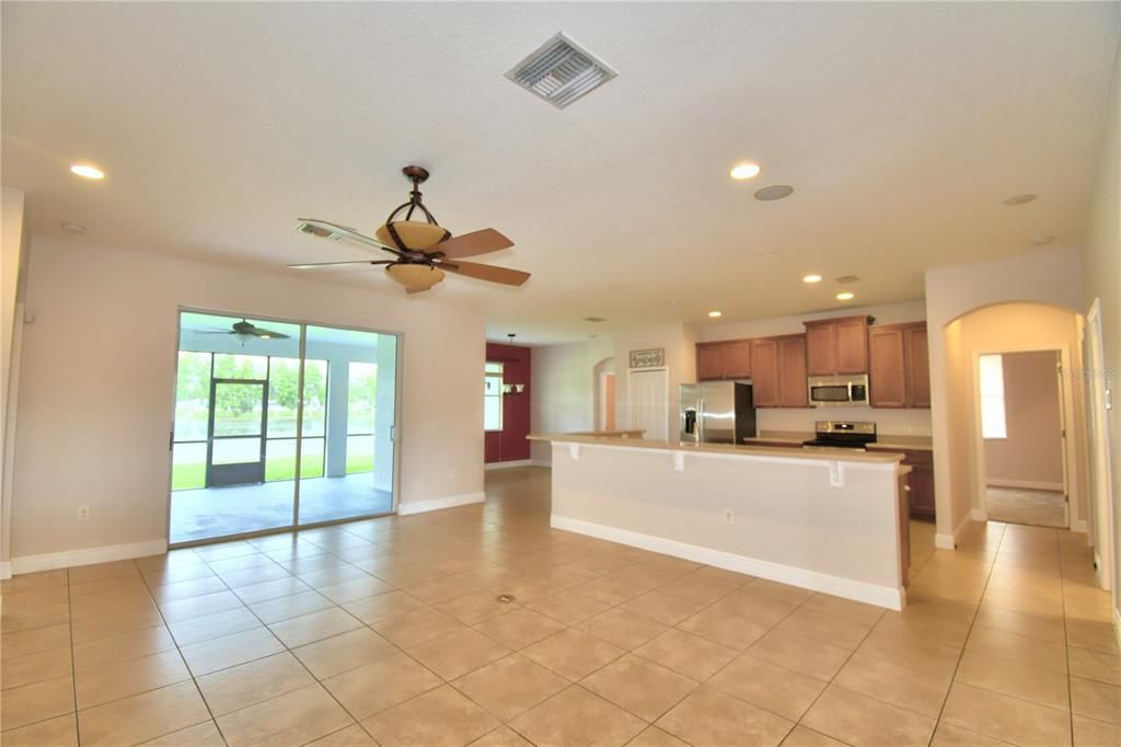 View from family room toward covered screened lanai which opens to back yard and lake