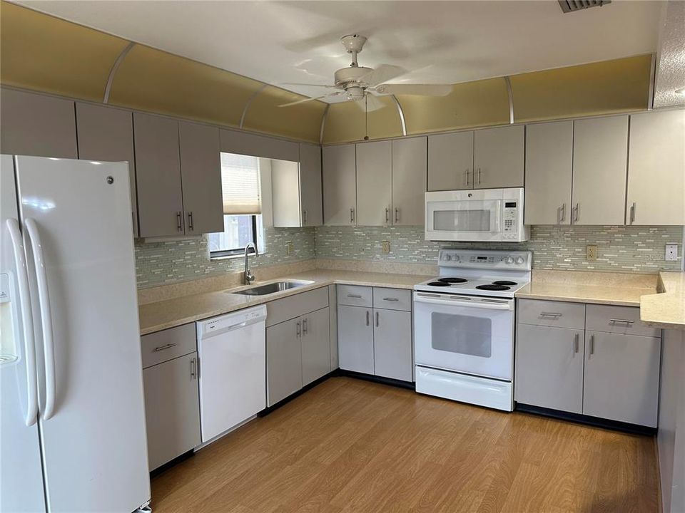 Spacious kitchen with tile backsplash