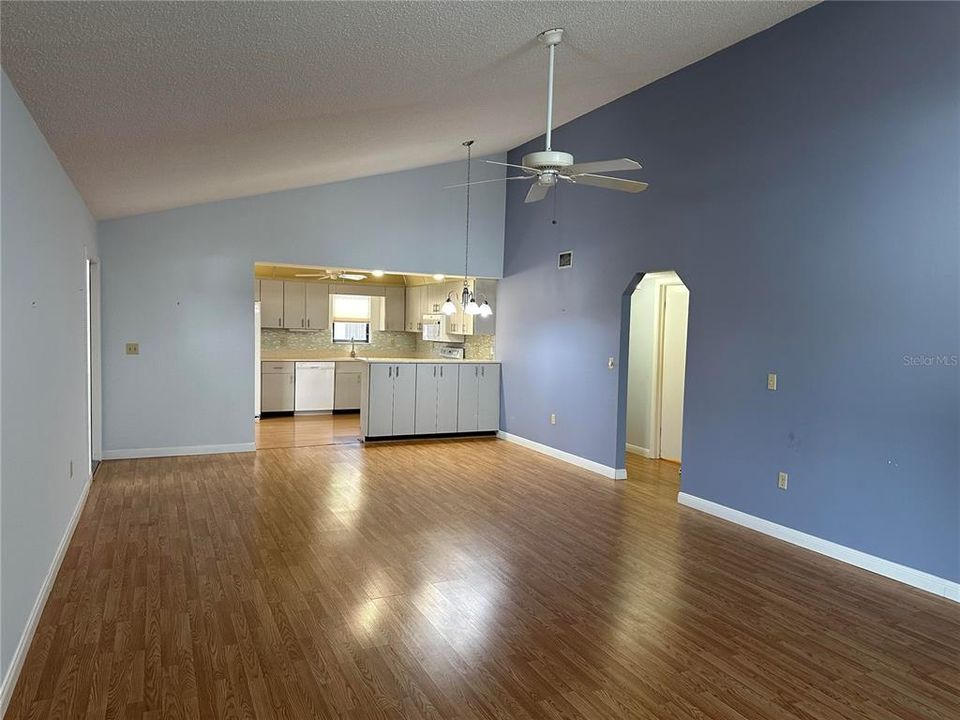 Great room with vaulted ceilings and view to kitchen.