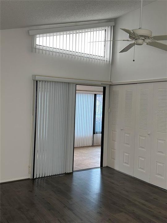 Vaulted ceiling in primary bedroom. Door to bonus room and laundry room