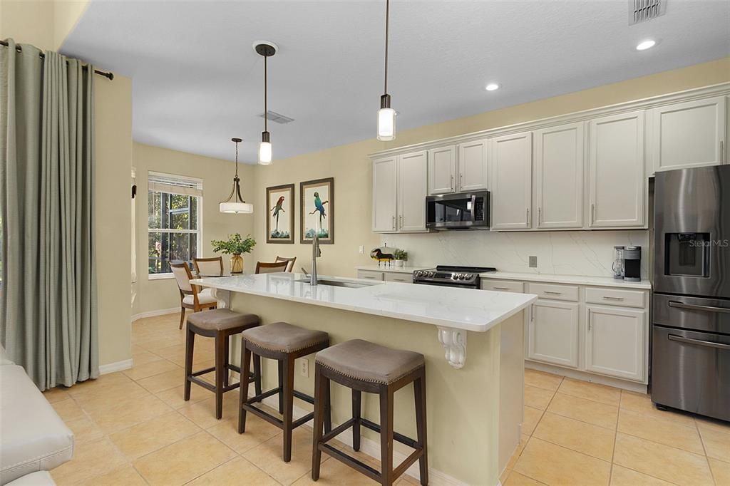 New granite counter top Island with breakfast bar.  New Appliances, pendant lighting and breakfast nook