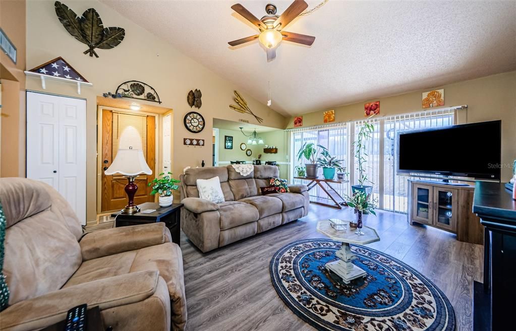 View of entrance with two (2) closets, luxury vinyl flooring, ceiling fan