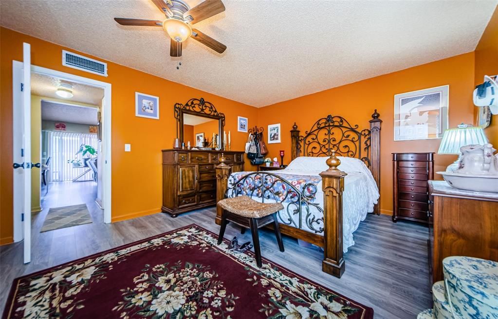 Spacious master bedroom with ceiling fan