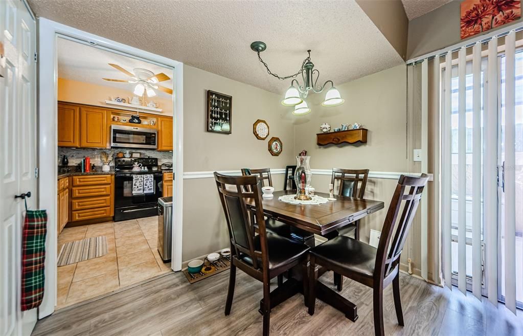 Dining area with chair rail, storage closet looking into kitchen