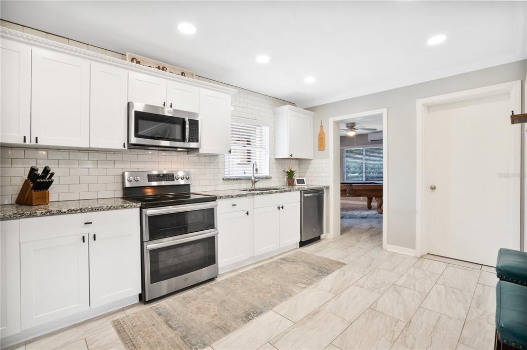 Completely Renovated kitchen with Stainless Steel Appliances including dual oven with INDOOR Laundry Room off of the Kitchen