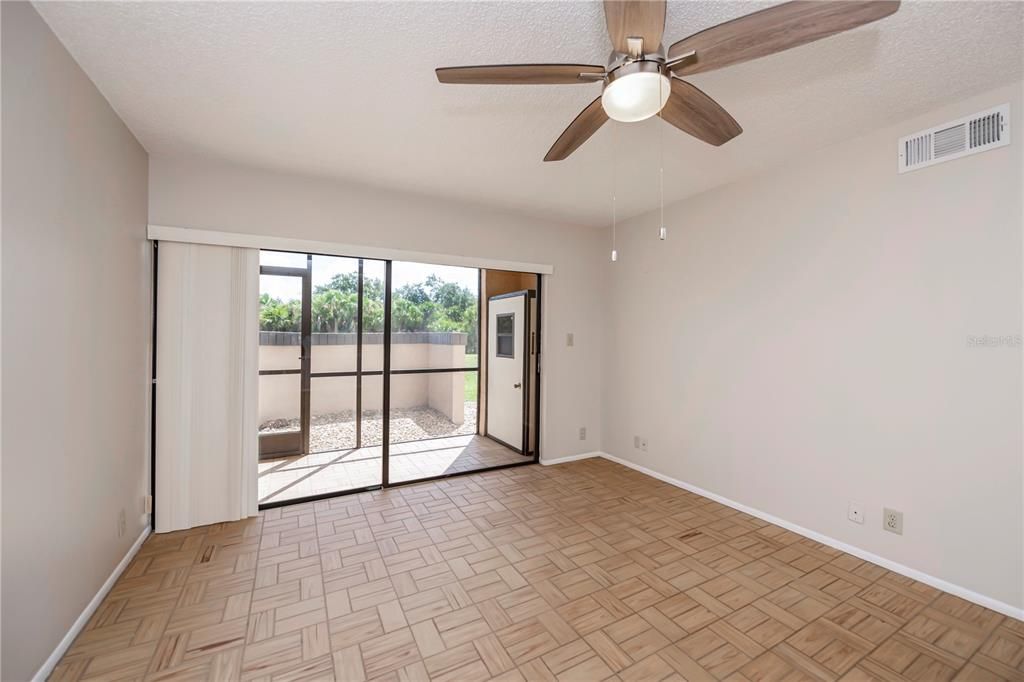 Sliders out to tiled lanai w/storage closet