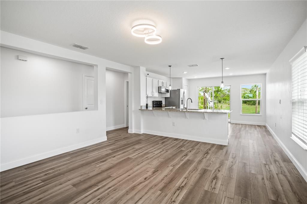 Living room overlooks the granite counter tops kitchen.