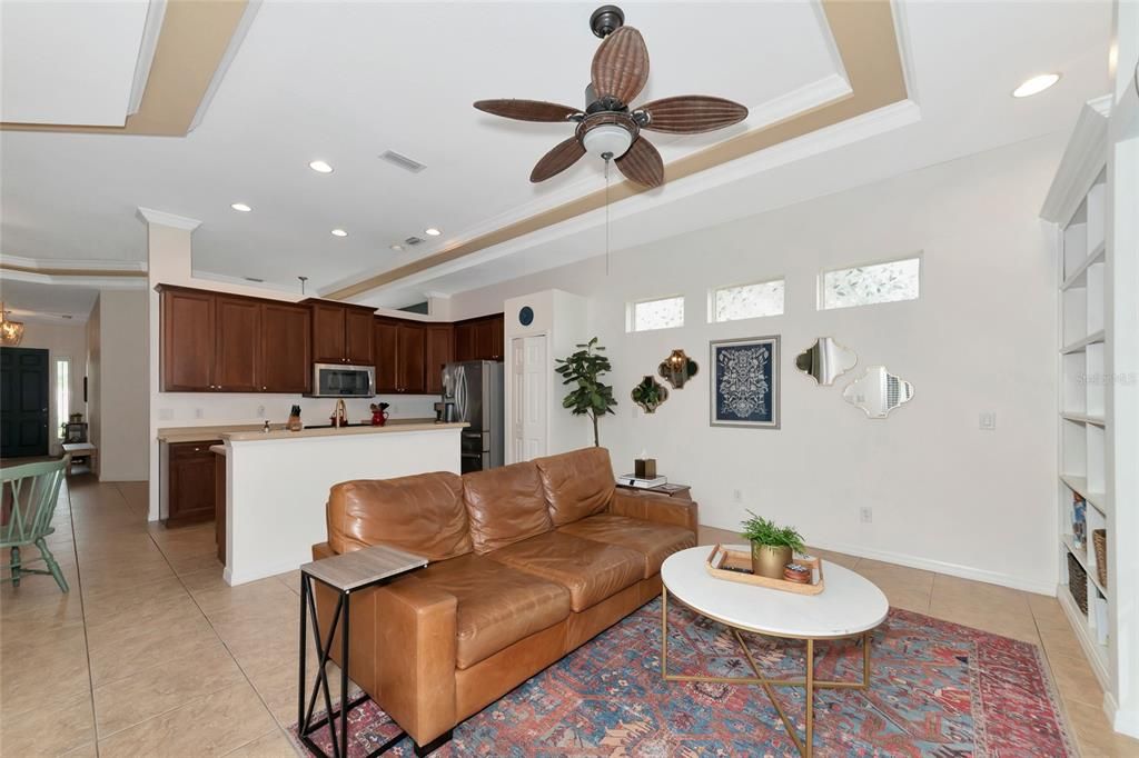 family room with tray ceiling and crown molding