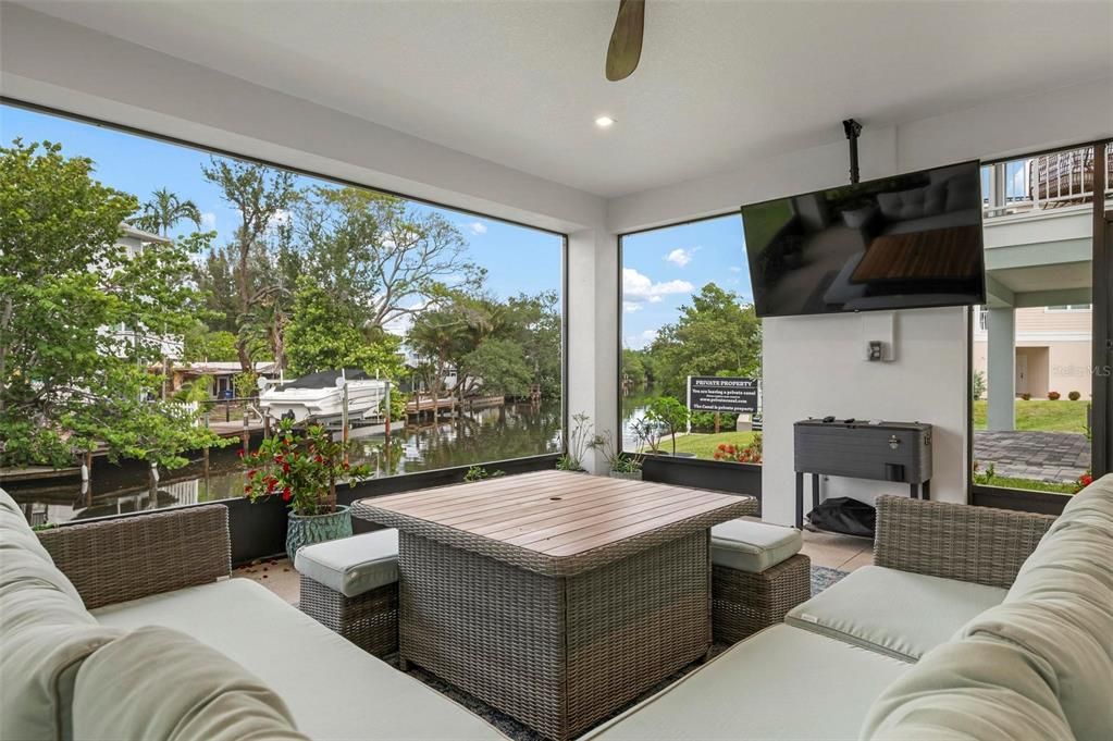 Ground level screened patio overlooking the canal