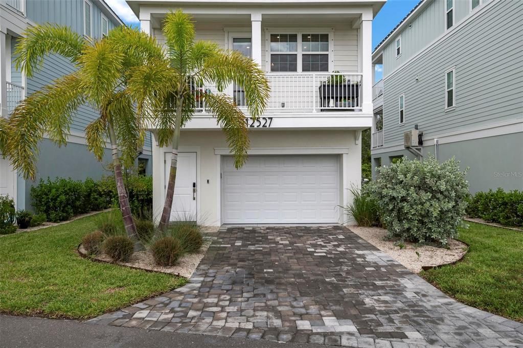 Front entrance and 2 car tandem garage with charging station for an electric vehicle