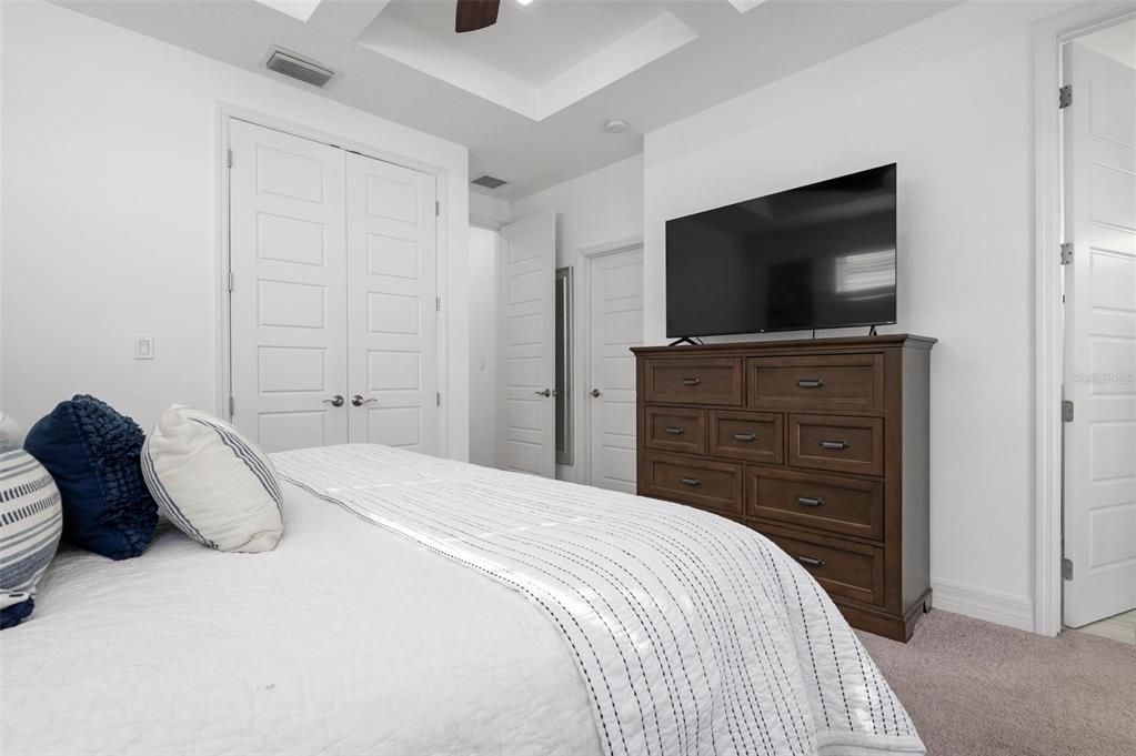 Primary bedroom with ensuite bath and balcony