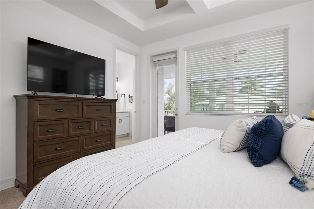 Primary bedroom with ensuite bath and balcony