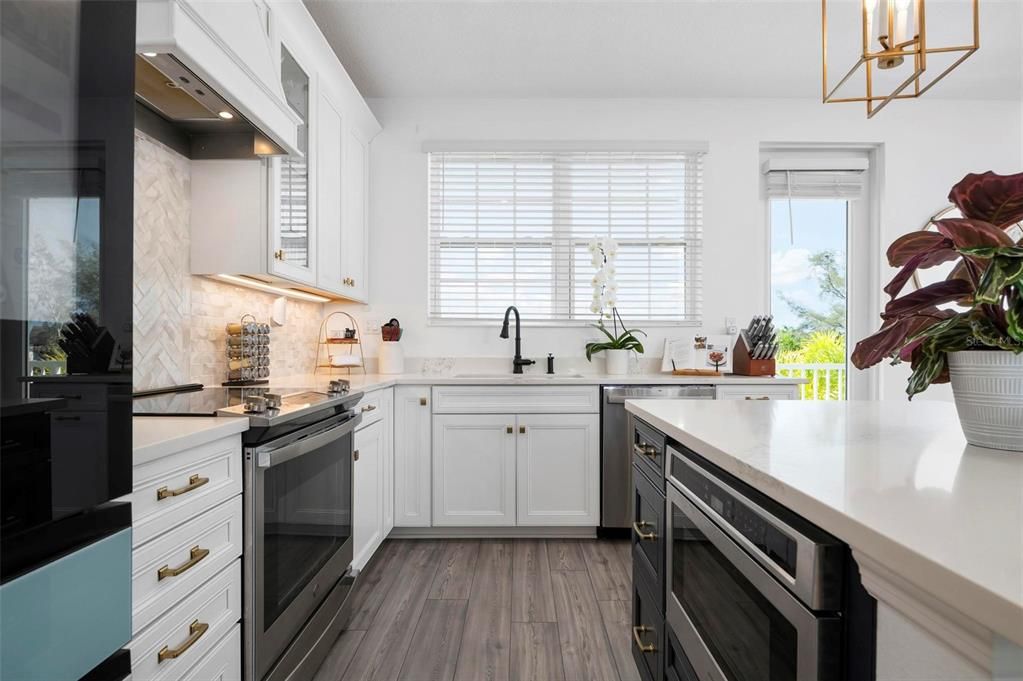 Kitchen with upgraded appliances and quartz counter tops