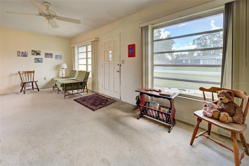 Large windows light the living room area.