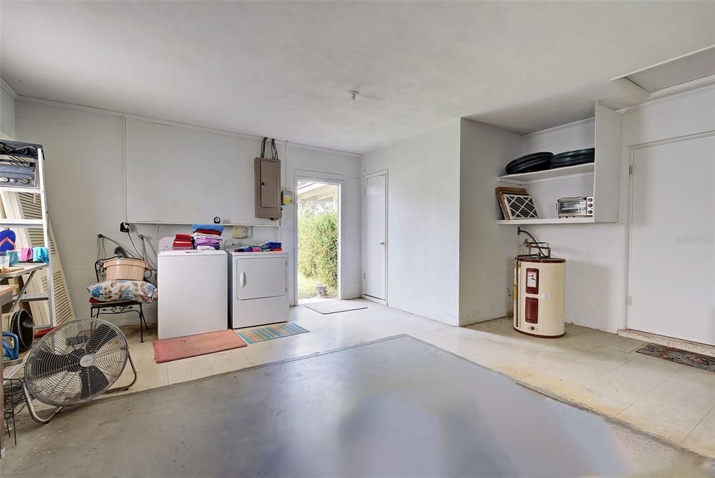 The washer and dryer are in the oversized garage, with a door to the back yard.