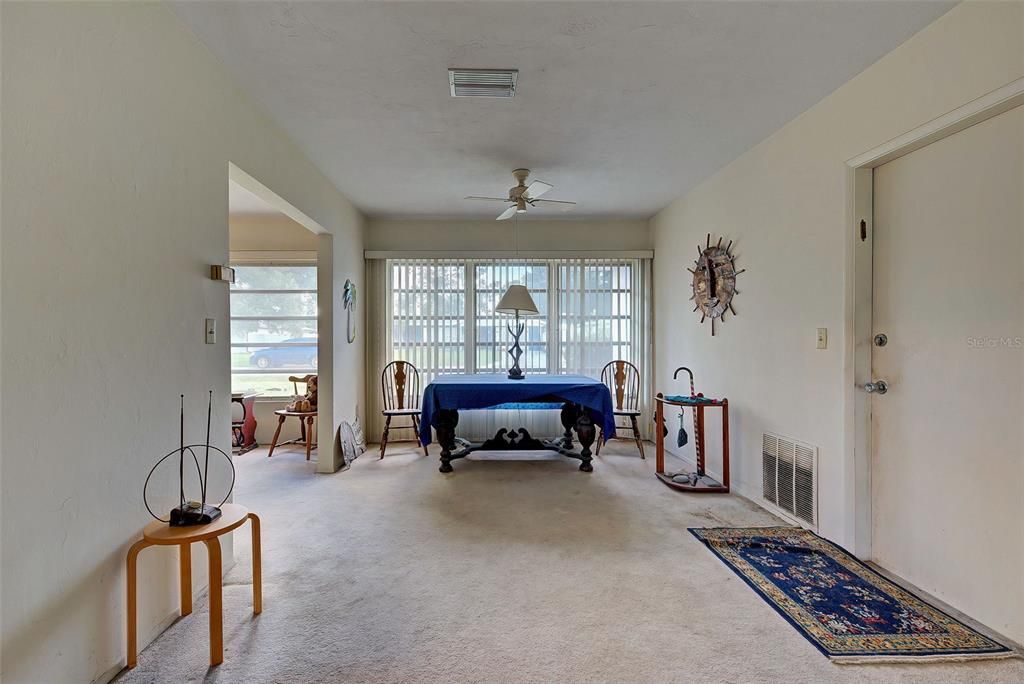 A view of the dining room from the back of the house looking to the front.  The garage door is on your right from this perspective.