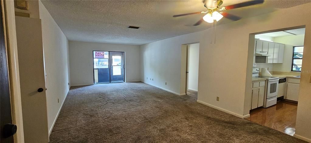 Living and dining area. Washer/Dryer combo behind the front door.
